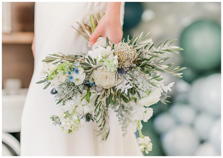 bridal bouquet with white poppies and blue thistle