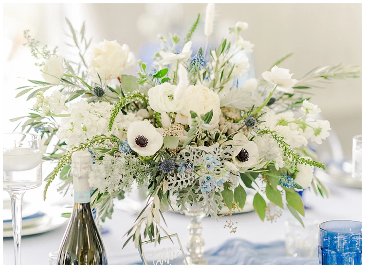 calla blue florals bridal floral arrangement with white poppies and blue thistle denver wedding