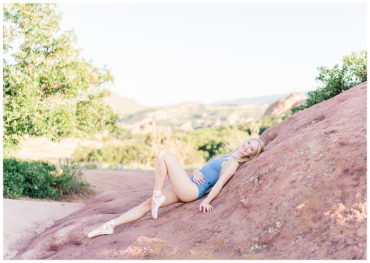 ballet dancer laying on red rocks