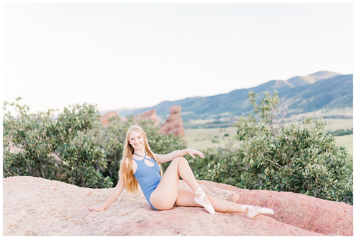 ballet dancer sitting on red rocks