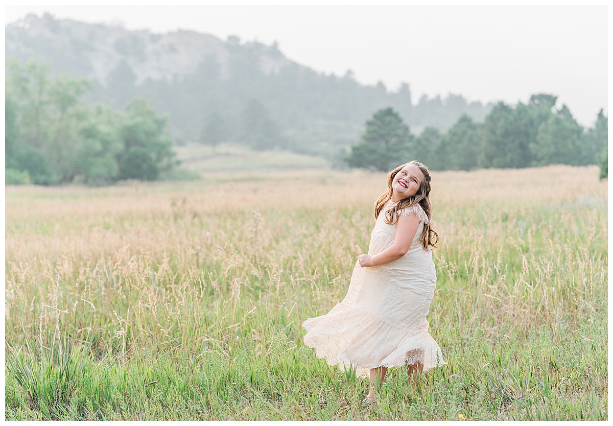 girl in lace dress dances in the field