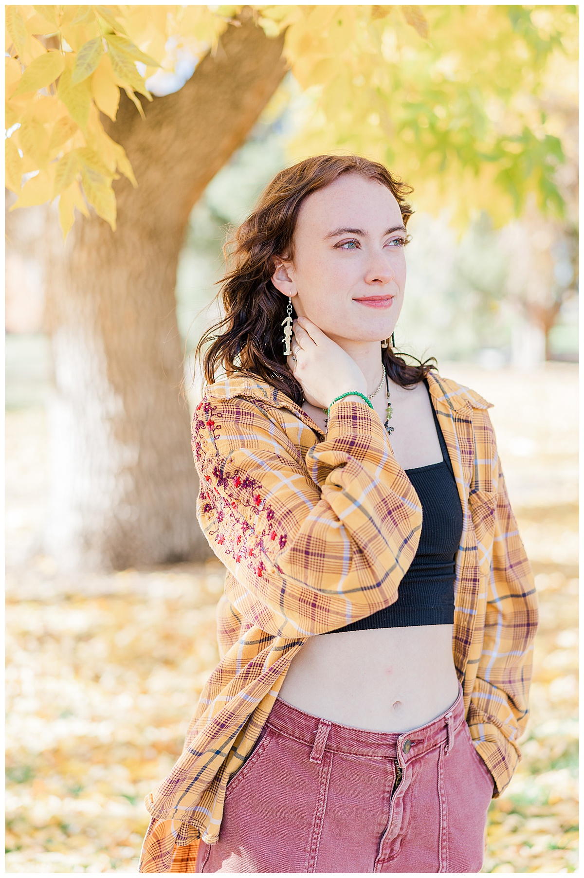 girl in yellow plaid shirt and fall foliage