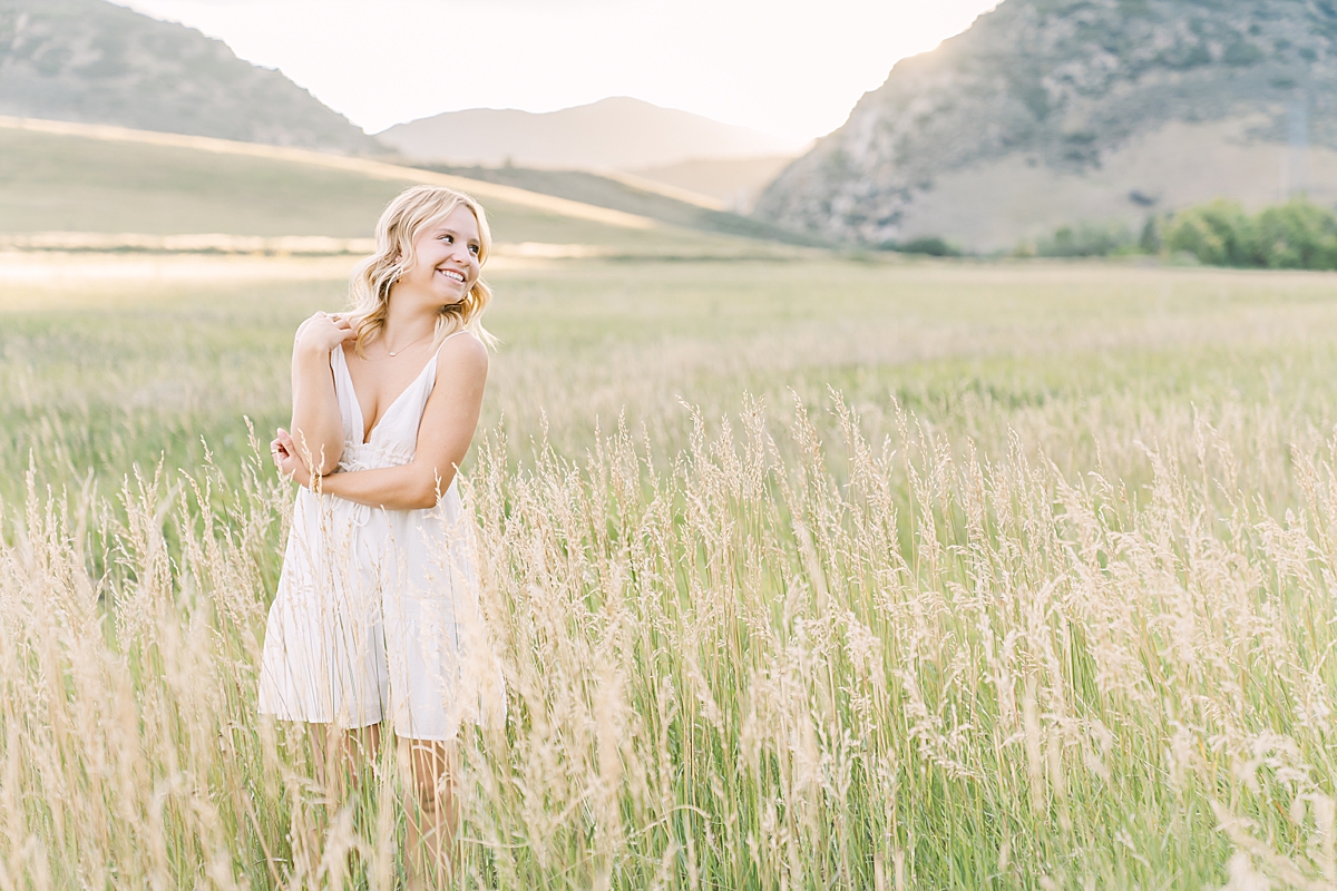 A Littleton senior stands in the field at Hildebrand Ranch.