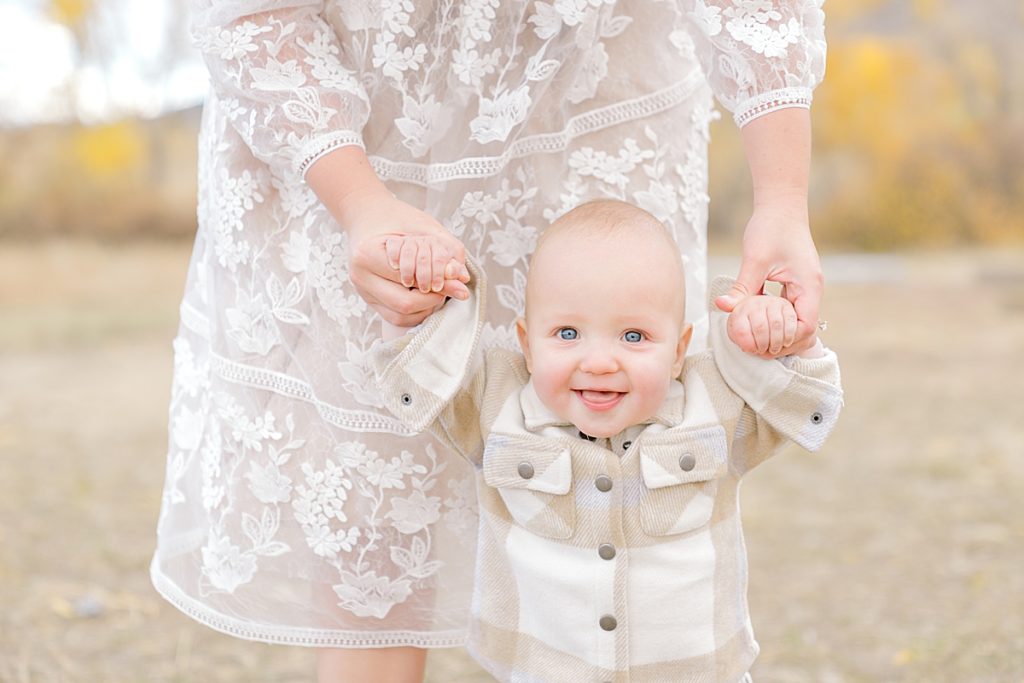 A cute baby smiles at the camera.