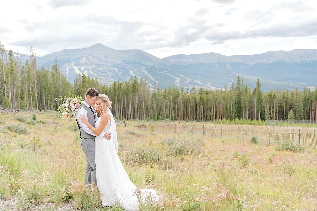 Breckenridge summer wedding photographer captures bride and groom embracing.
