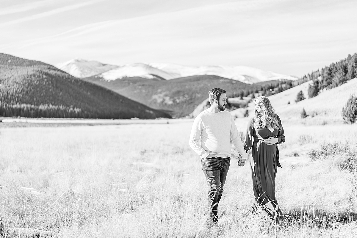 A couple expecting their first child walks in the meadow near Burning Bear campground.