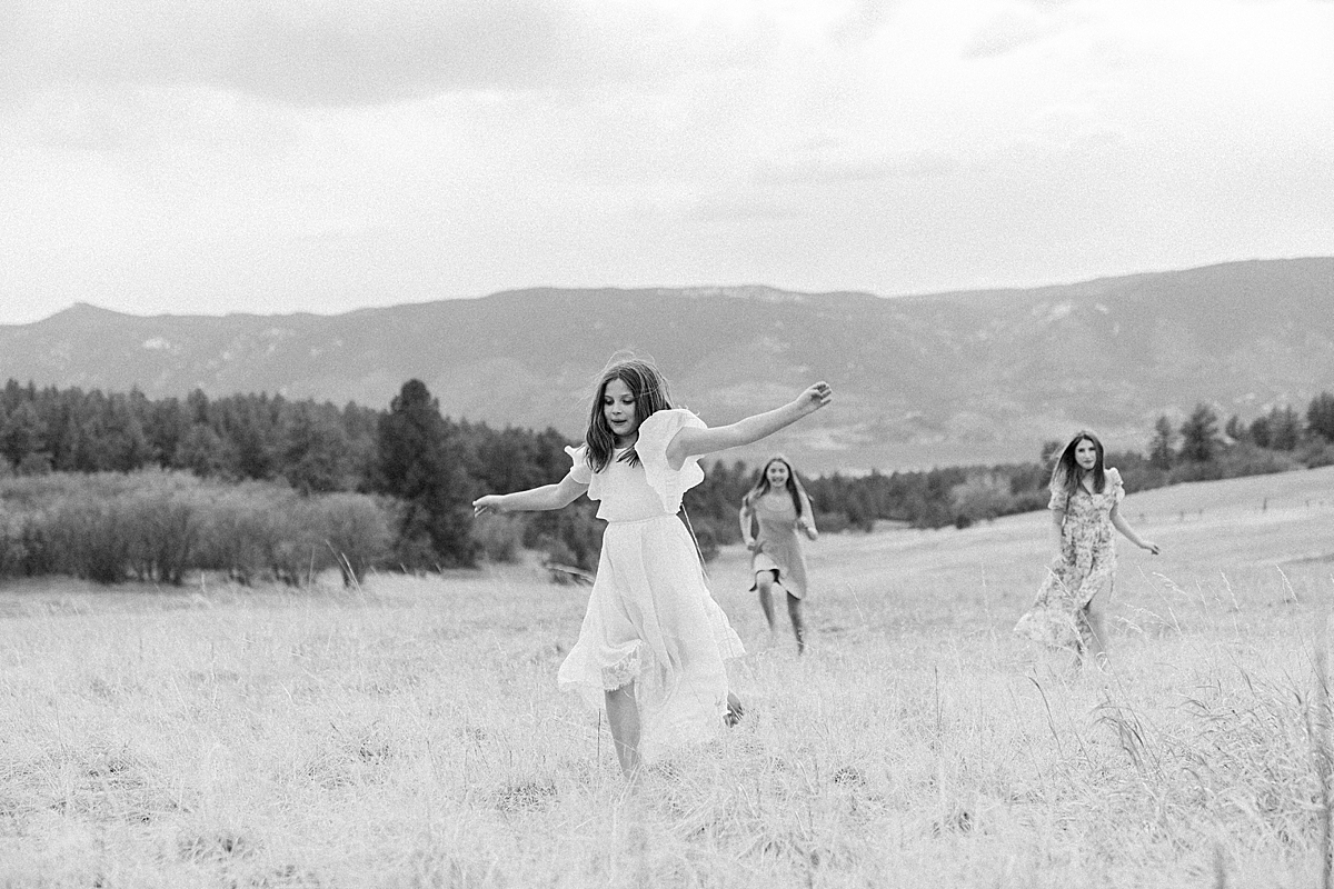 Three sisters run in the field at Dawson's Butte in Castle Rock.