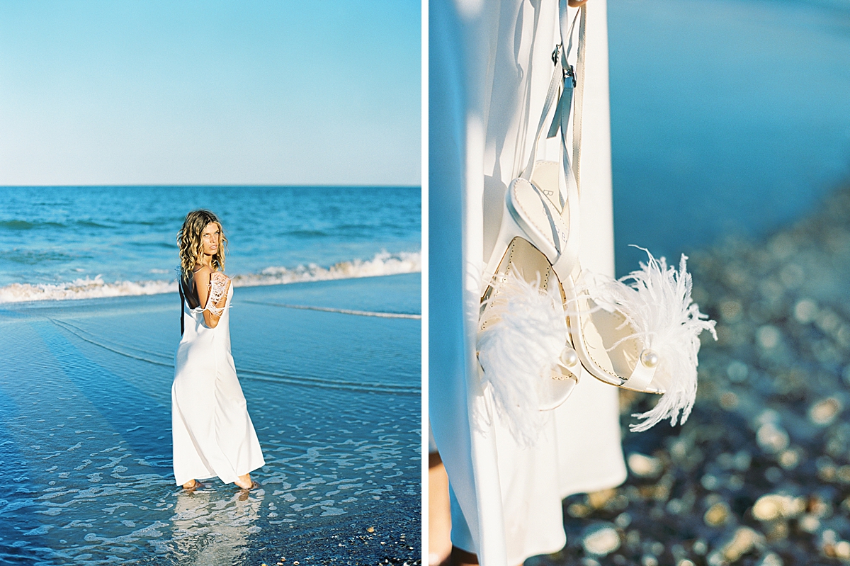 A bride holds her Bella Belle shoes by the ocean in Florida.