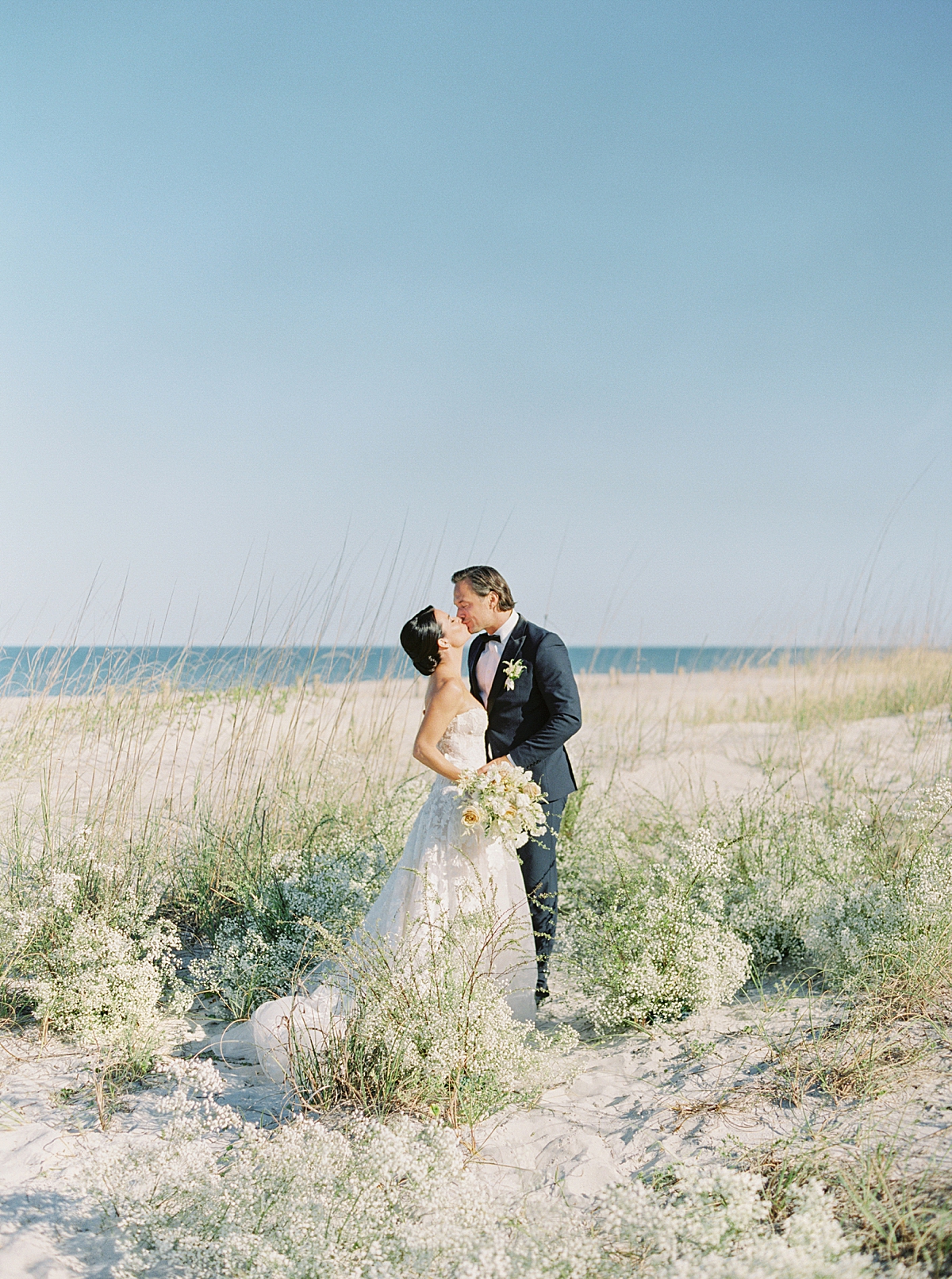 Mary Ann Craddock is a luxury beach wedding on film photographer.