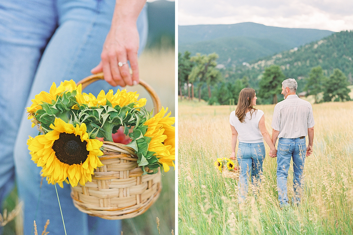 An engagement photoshoot with sunflowers as a couple walks through a field