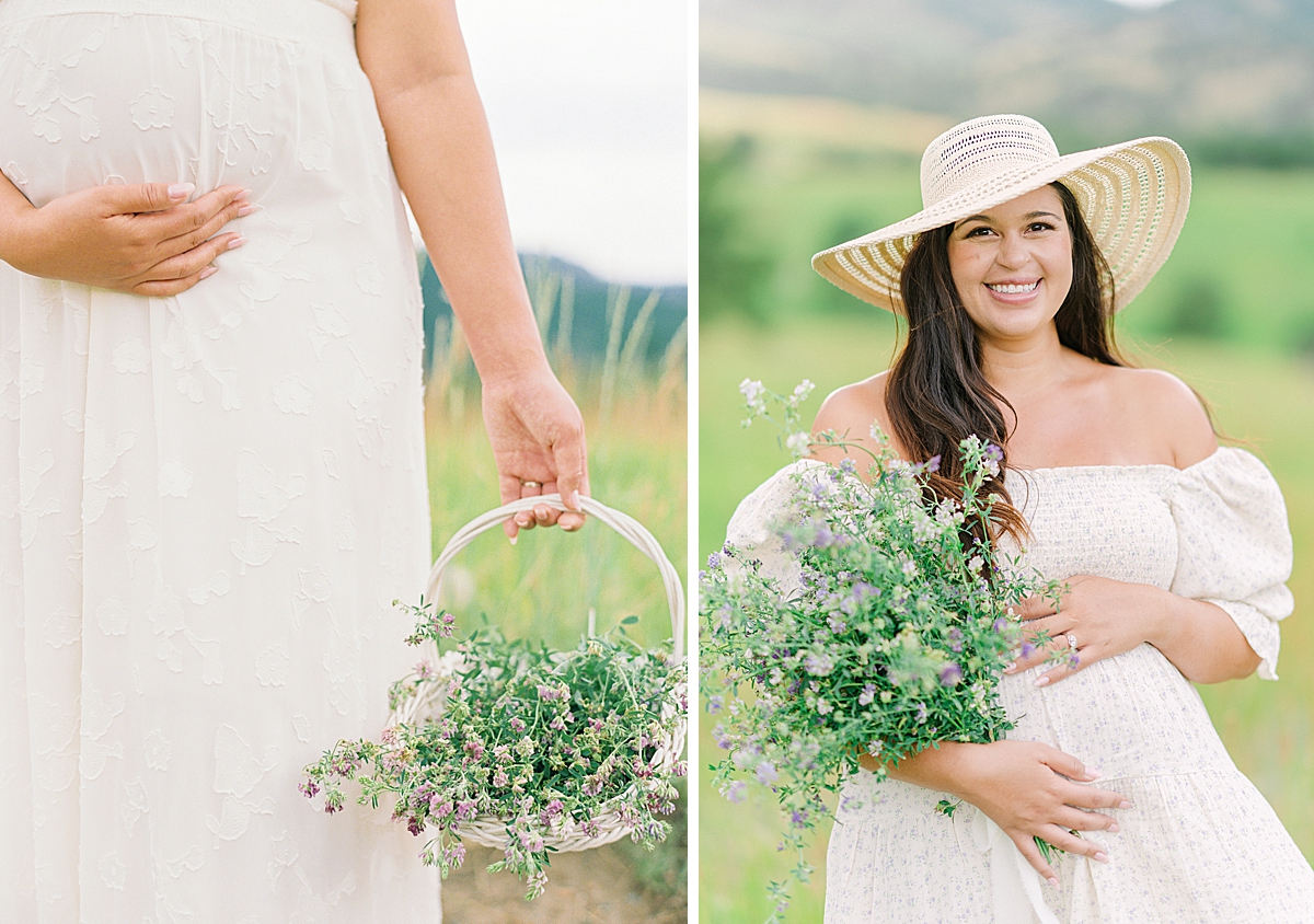 A pretty pregnant lady smiles at the camera while cradling her belly and a bouquet of summer wildflowers.