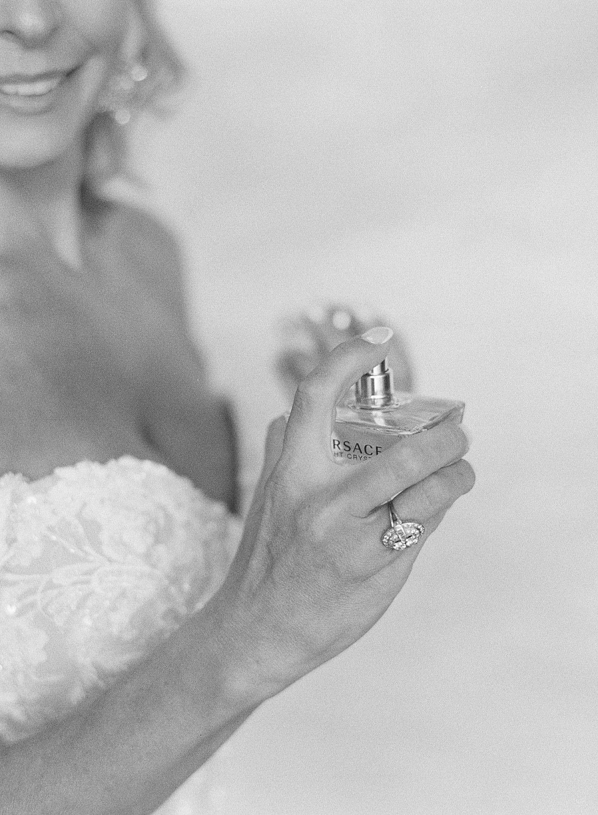 A bride sprays Versace perfume at her Villa Parker wedding