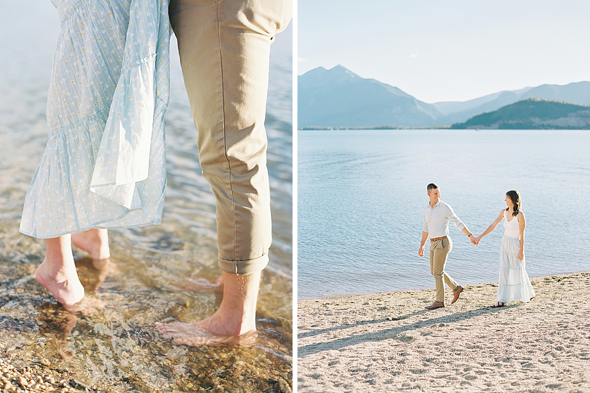 A guy and girl walk along the sand at Lake Dillon in Colorado.