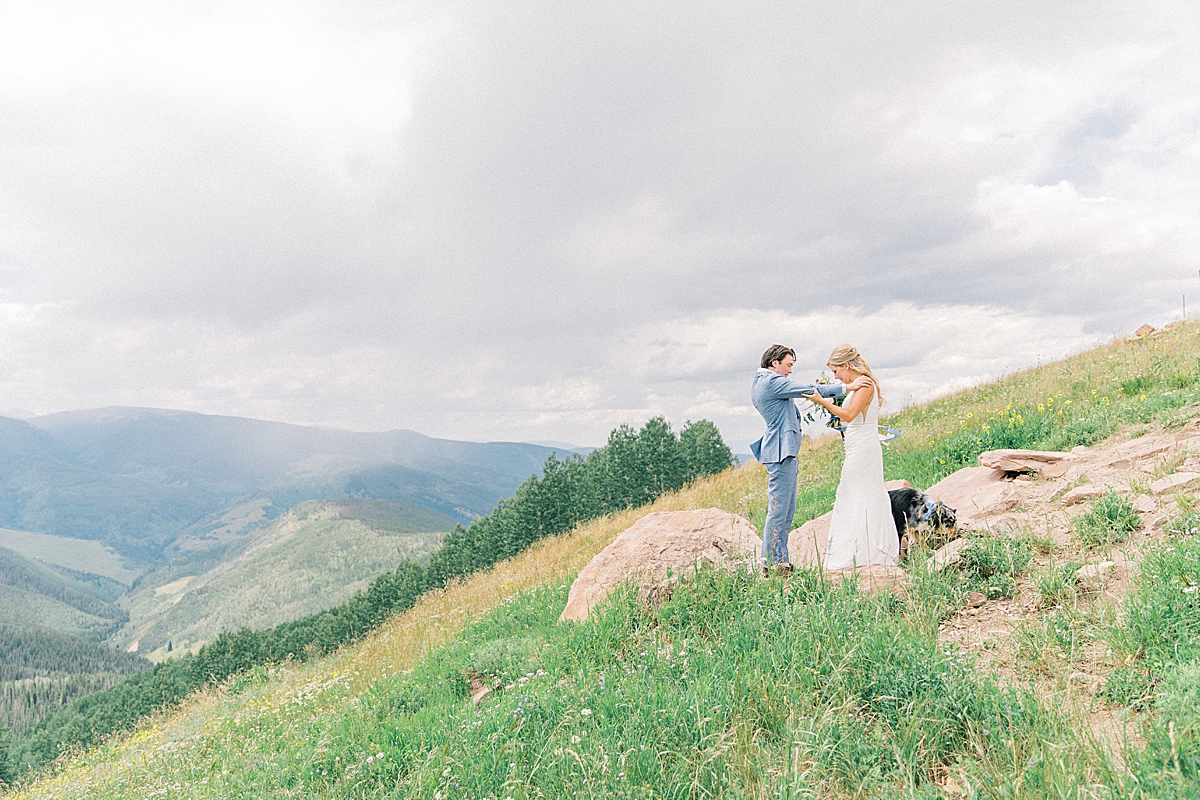 A bride and groom share a first look at the Vail mountain wedding deck.