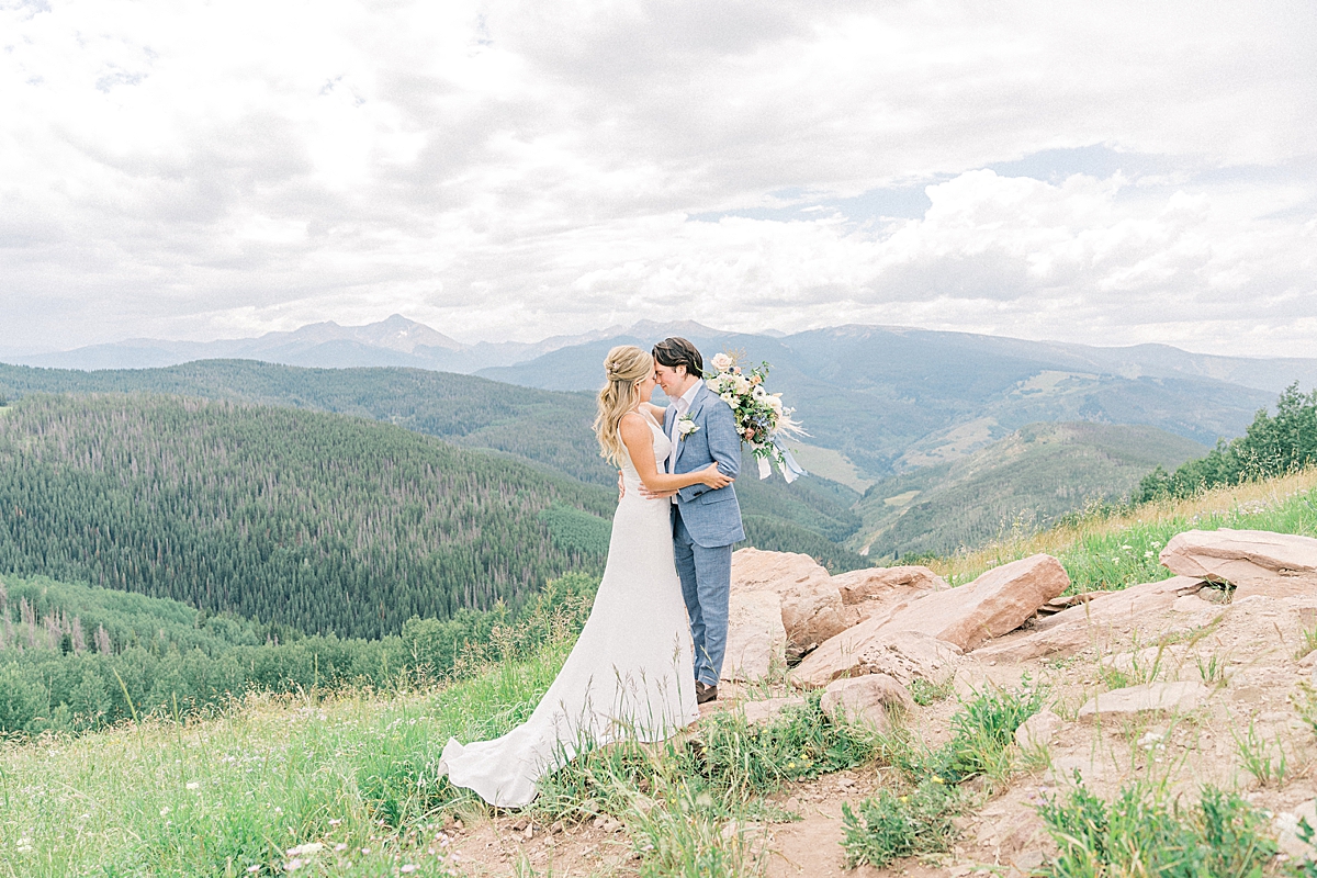 A bride and groom embrace on Vail mountain.