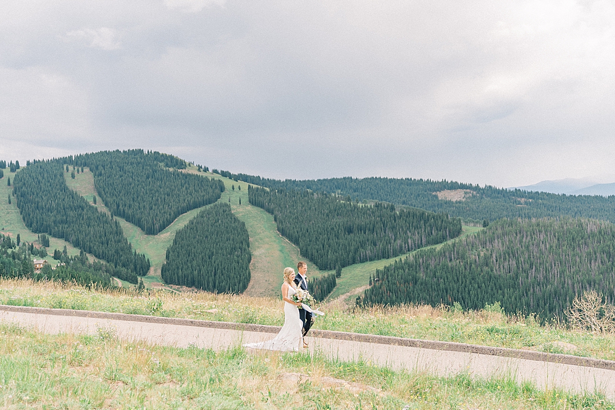 Dad walks his daughter down the aisle to the vail mountain wedding deck.