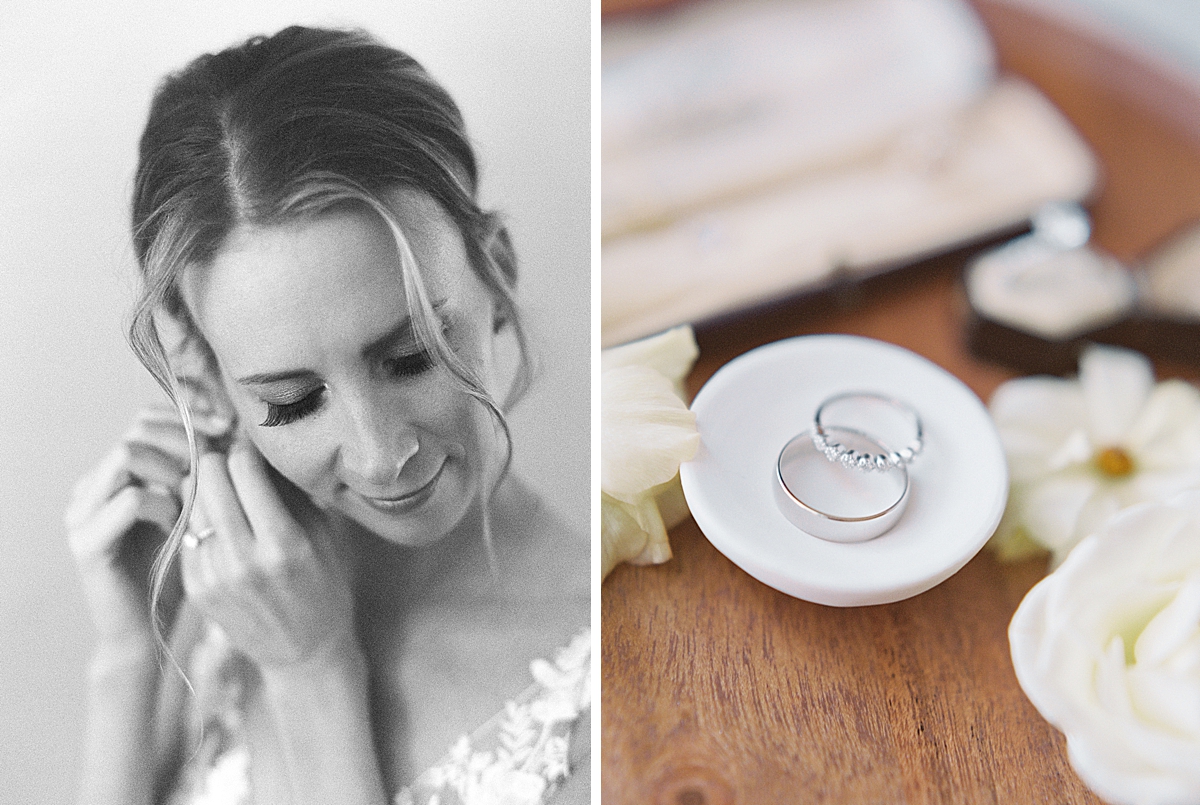 A bride puts on her earrings on black and white film.