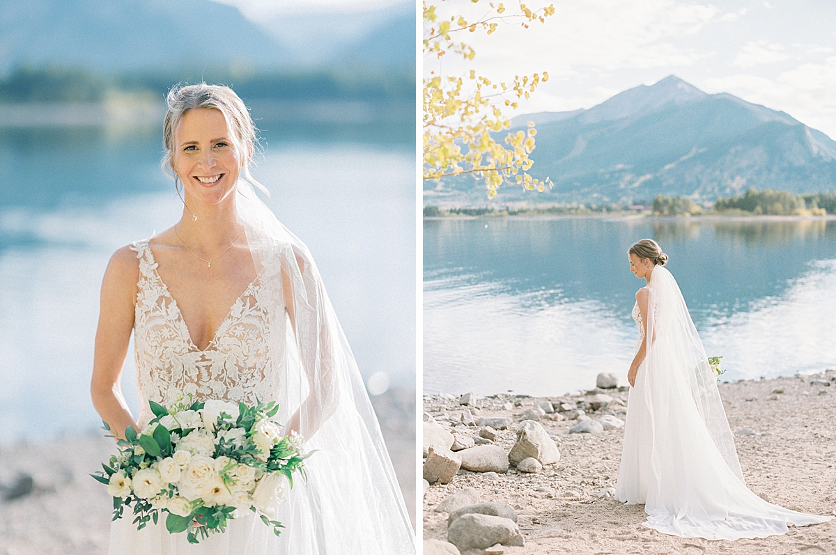a beautiful bride stands by Lake Dillon for bridal portraits