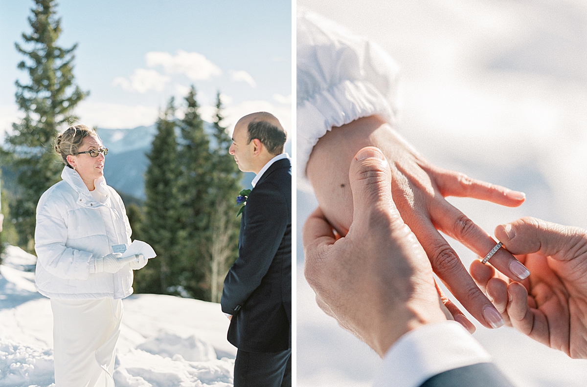 A groom places a wedding ring on his bride's finger, on top of a snowy mountain.