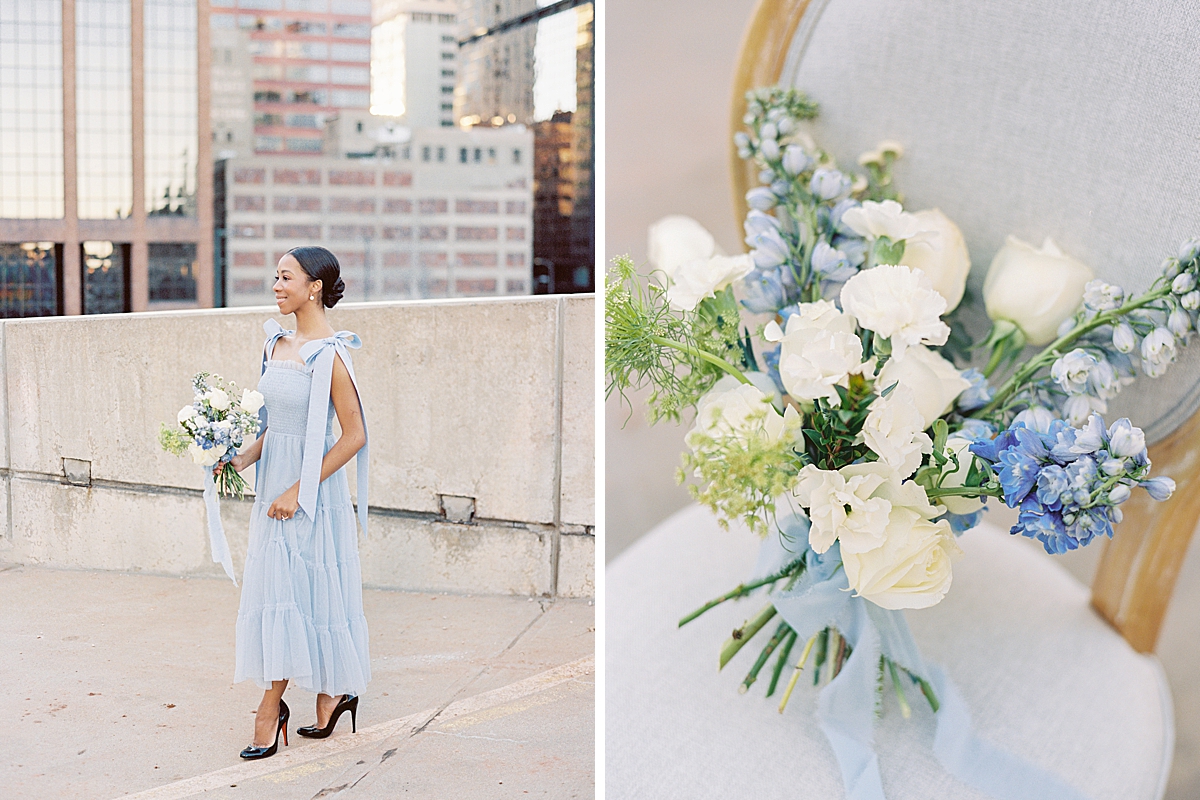 A beautiful hand-tied spiral bouquet of roses, delphiniums, and carnations sits on a French chair.