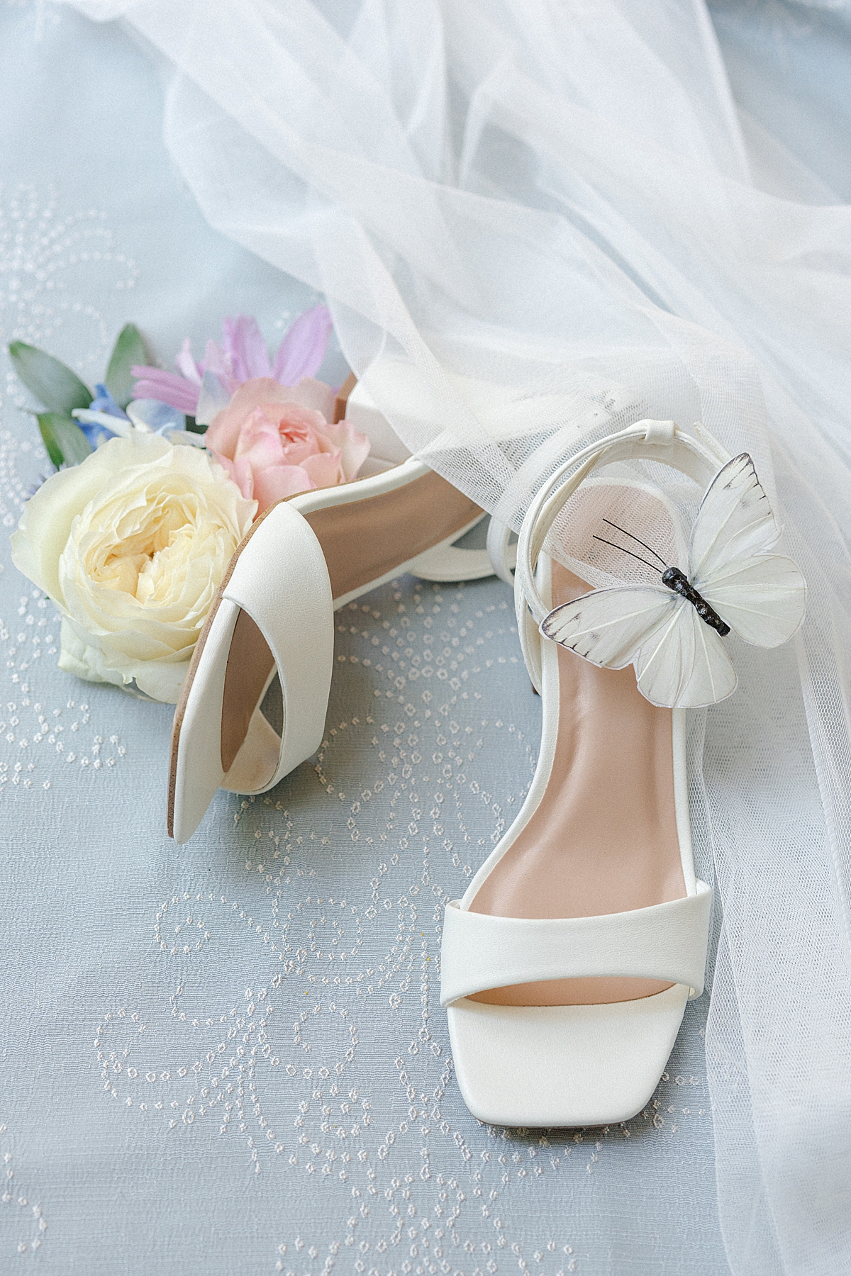 A wedding shoe flat lay using a BBJ La Tavola linen as a styling surface.