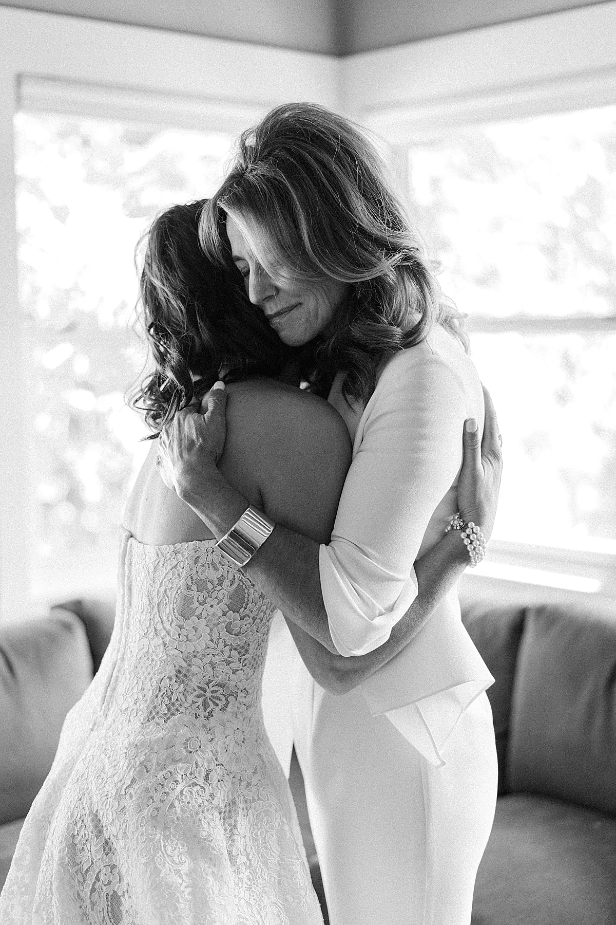 A bride hugs her Mom while getting ready for her wedding.