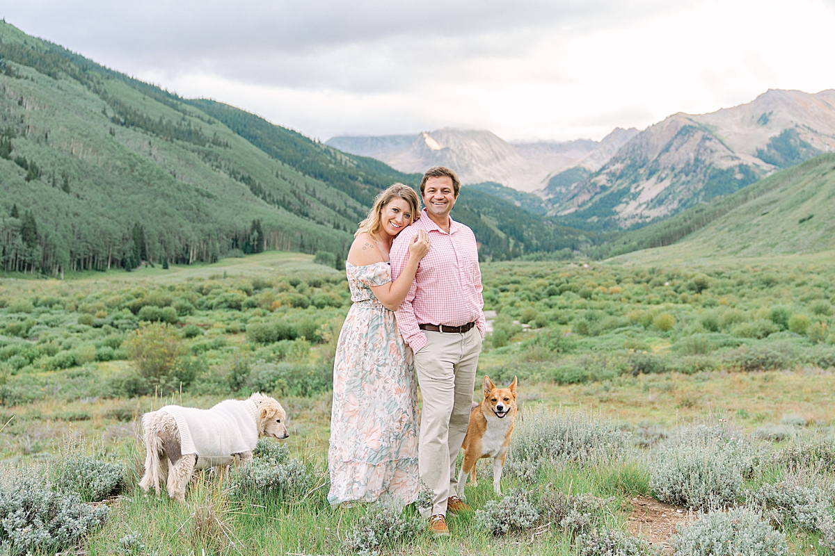 A couple poses at Ashcroft for their Aspen Colorado engagement photos, with their dogs.
